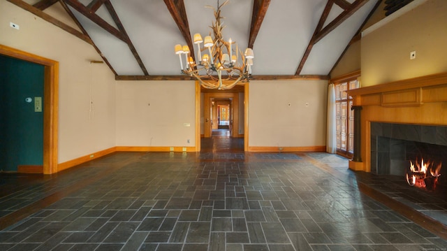 unfurnished living room with an inviting chandelier, beam ceiling, a tile fireplace, and high vaulted ceiling