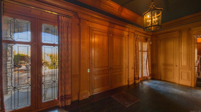 entrance foyer with french doors and a notable chandelier