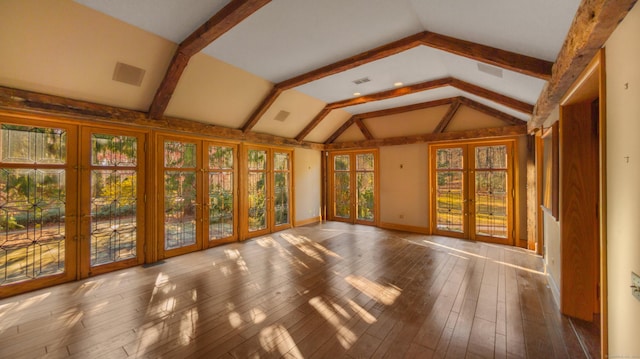 unfurnished sunroom featuring a healthy amount of sunlight, french doors, and lofted ceiling with beams