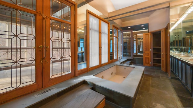 bathroom featuring a tub and french doors