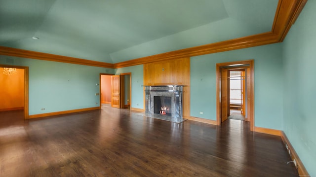 unfurnished living room with lofted ceiling, a chandelier, crown molding, and dark hardwood / wood-style floors