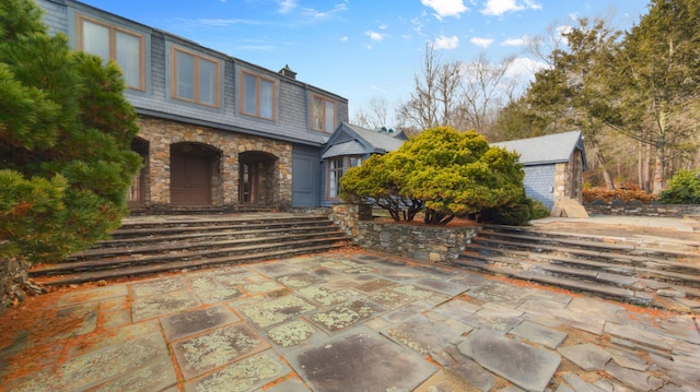 view of patio featuring a storage shed