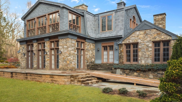 rear view of property with a yard, french doors, and a patio