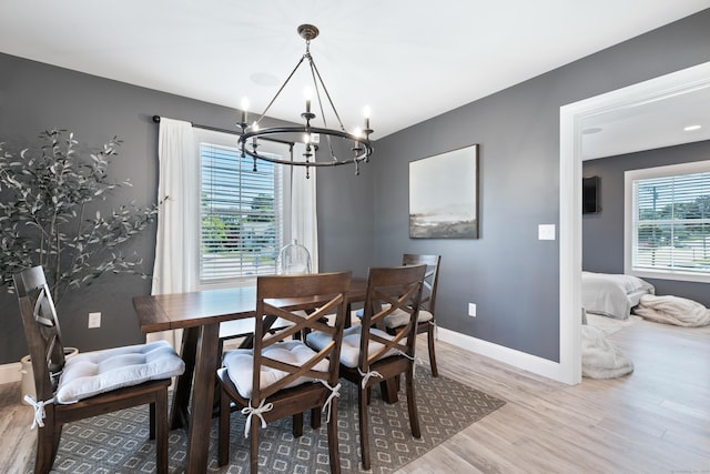 dining room with hardwood / wood-style flooring and a notable chandelier