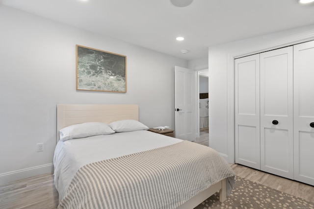 bedroom with light hardwood / wood-style flooring and a closet