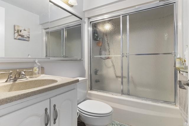 full bathroom featuring vanity, enclosed tub / shower combo, and toilet