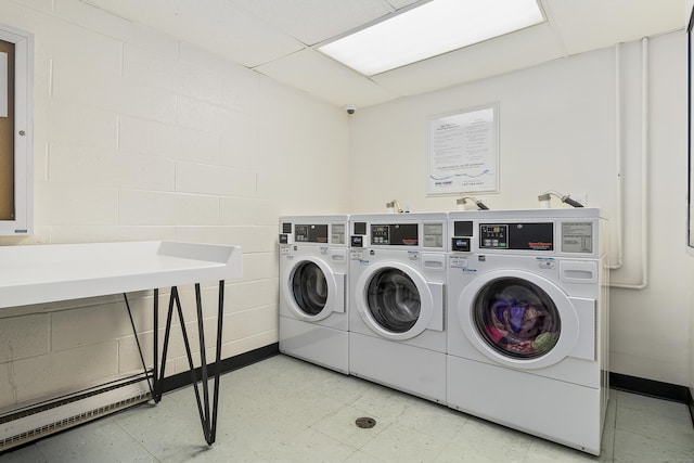 laundry area featuring a baseboard radiator and washing machine and clothes dryer