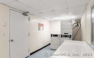 laundry area featuring washing machine and clothes dryer and stacked washer and dryer