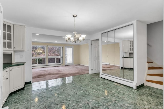 interior space featuring a baseboard radiator, dark carpet, and a notable chandelier