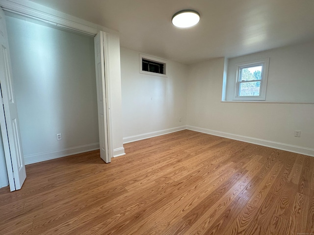 basement with light hardwood / wood-style flooring