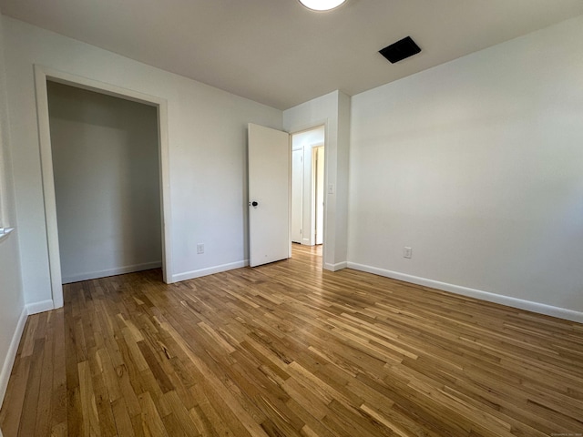 unfurnished bedroom featuring hardwood / wood-style floors