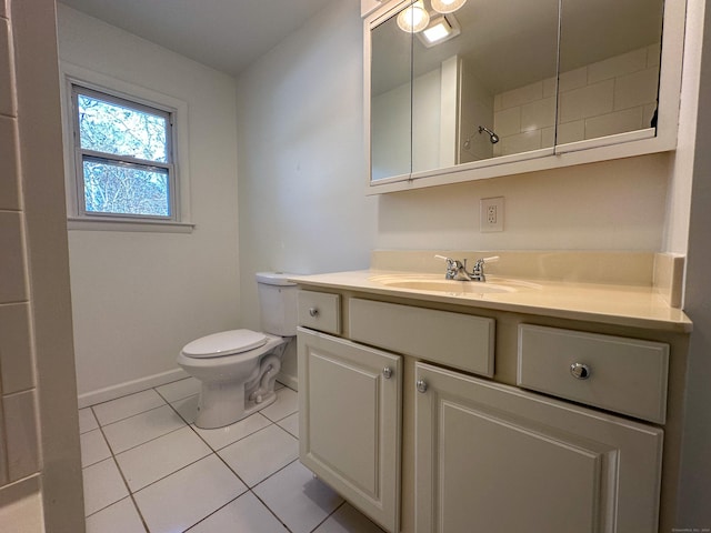 bathroom with tile patterned flooring, vanity, and toilet