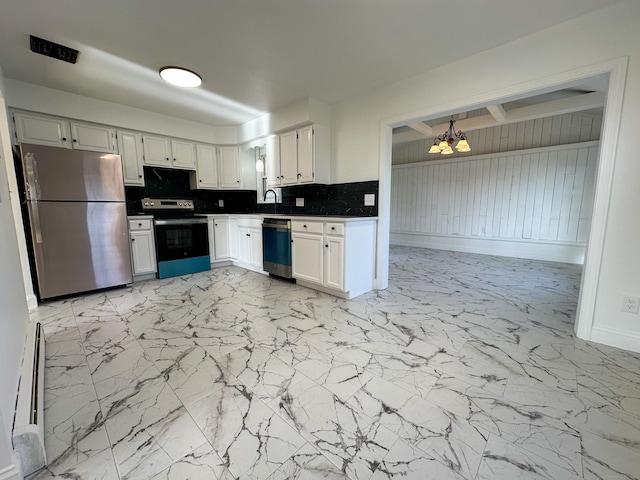 kitchen with white cabinets, backsplash, stainless steel appliances, and an inviting chandelier