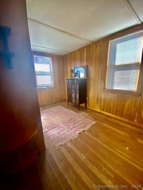 interior space with wood walls and wood-type flooring