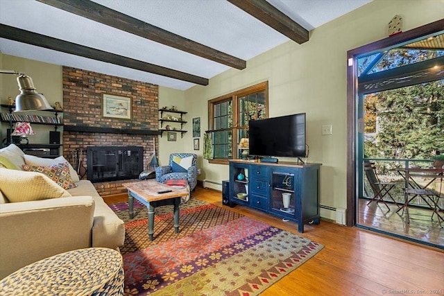 living room with beam ceiling, a baseboard radiator, a wealth of natural light, and hardwood / wood-style flooring