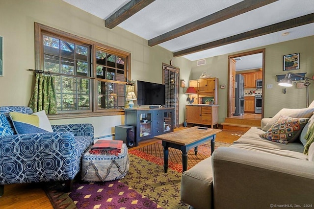 living room featuring beamed ceiling, hardwood / wood-style floors, and a baseboard radiator