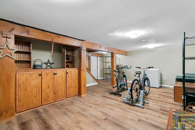 workout room featuring light wood-type flooring