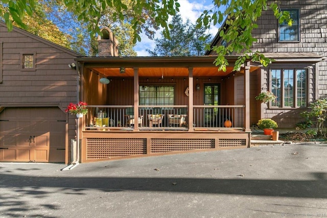 view of front facade featuring a porch and a garage