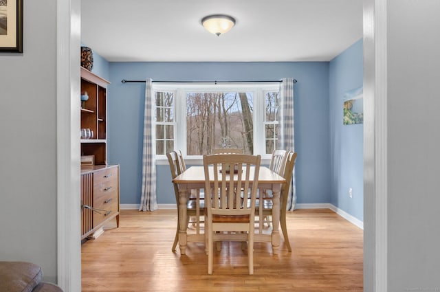 dining space with light wood-type flooring