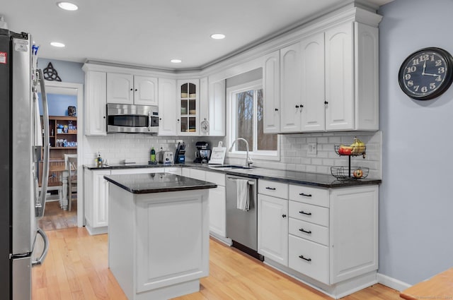 kitchen featuring white cabinets, a kitchen island, and appliances with stainless steel finishes