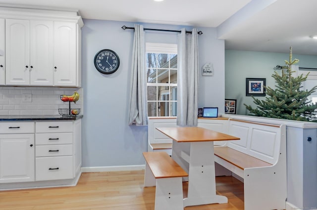 unfurnished dining area featuring breakfast area and light hardwood / wood-style floors