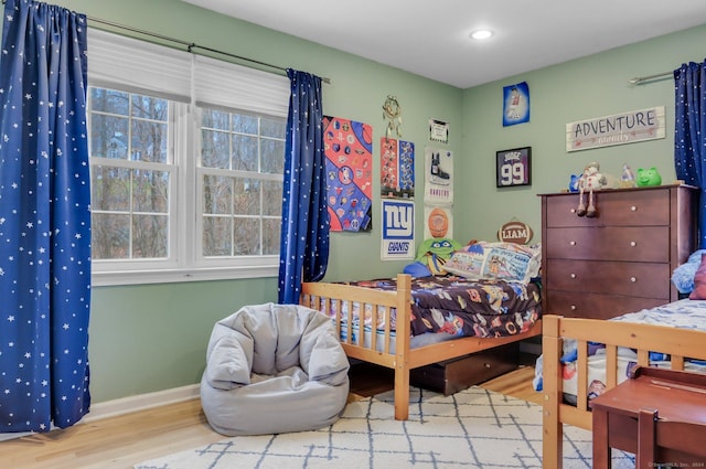 bedroom featuring light wood-type flooring and multiple windows