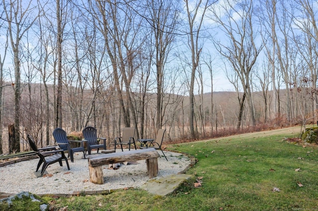 view of yard featuring a mountain view and an outdoor fire pit