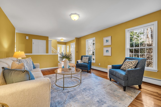 living room with hardwood / wood-style floors and a baseboard heating unit