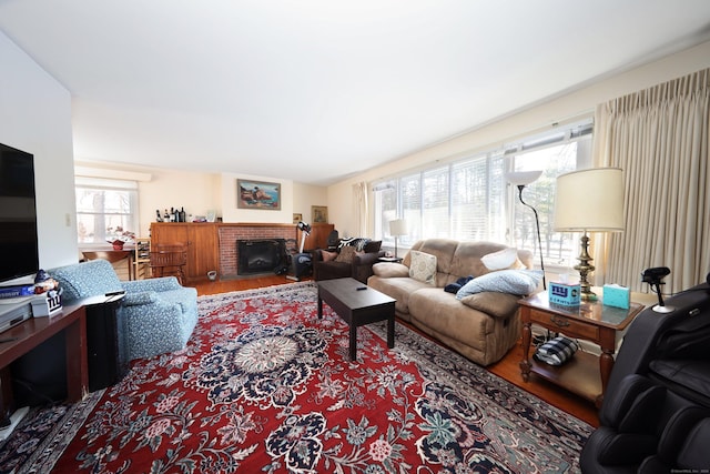 living room with hardwood / wood-style floors and a brick fireplace