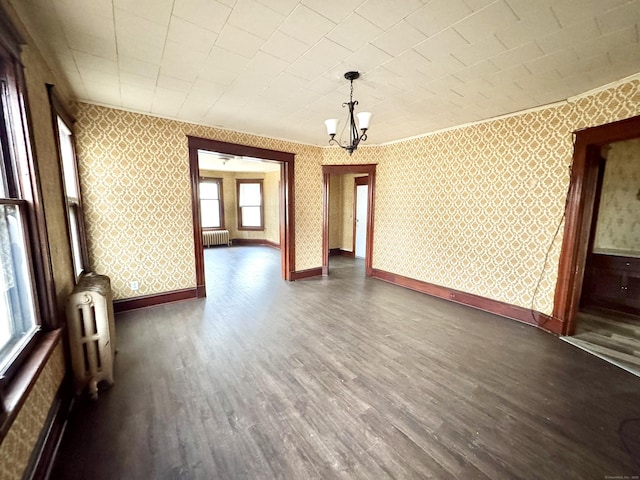 interior space featuring radiator, dark hardwood / wood-style flooring, and a chandelier