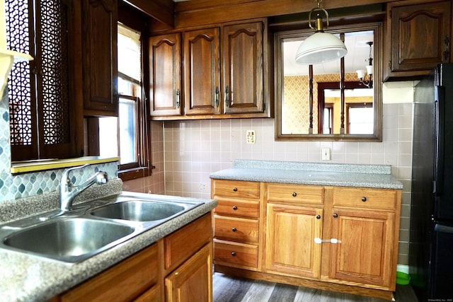 kitchen with refrigerator, dark hardwood / wood-style floors, a healthy amount of sunlight, and sink