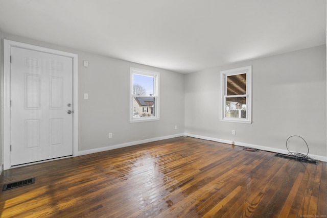 spare room with dark wood-type flooring