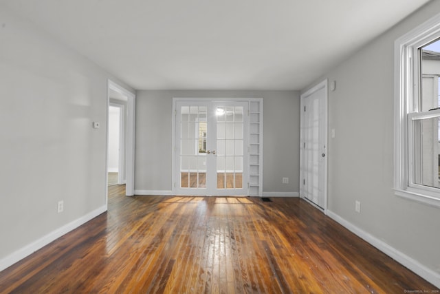 spare room with french doors and dark hardwood / wood-style floors