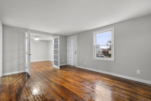 empty room with french doors and dark hardwood / wood-style floors