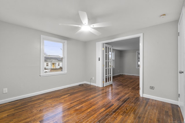 spare room featuring ceiling fan and dark wood-type flooring