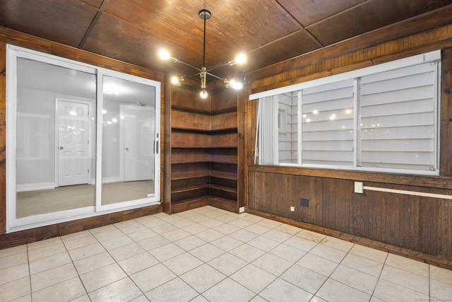 unfurnished room with wood walls and wood ceiling