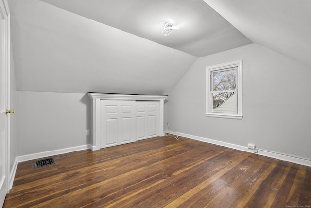 additional living space featuring dark hardwood / wood-style floors and lofted ceiling