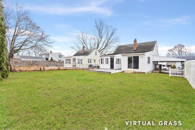 back of house featuring a yard and a carport