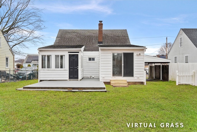 rear view of house with a lawn and a wooden deck