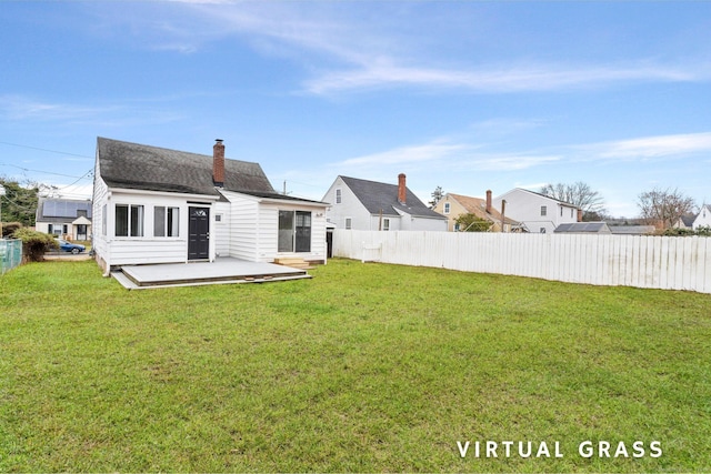 back of house featuring a lawn and a patio area