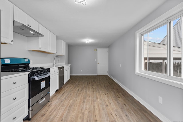 kitchen featuring white cabinets, appliances with stainless steel finishes, and light hardwood / wood-style flooring