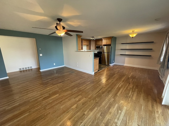 unfurnished living room with dark hardwood / wood-style floors and ceiling fan