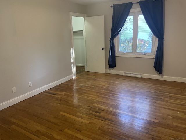 spare room with dark hardwood / wood-style floors