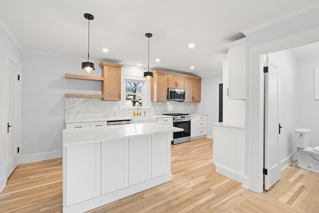 kitchen featuring appliances with stainless steel finishes, light wood-type flooring, hanging light fixtures, and light brown cabinetry