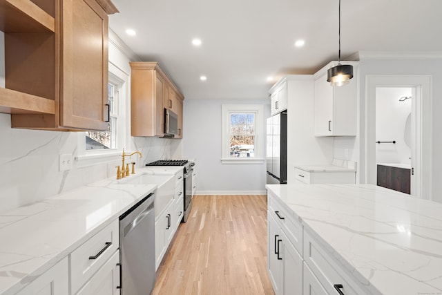 kitchen with white cabinets, light stone countertops, and appliances with stainless steel finishes