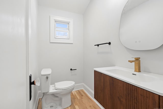 bathroom featuring hardwood / wood-style floors, vanity, and toilet