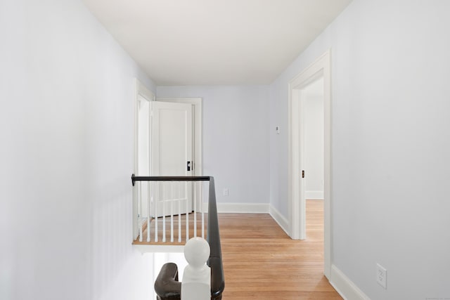 corridor with light hardwood / wood-style floors