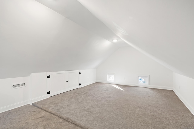 bonus room with carpet and lofted ceiling