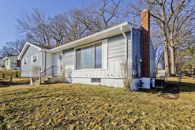 view of property exterior featuring central AC and a yard