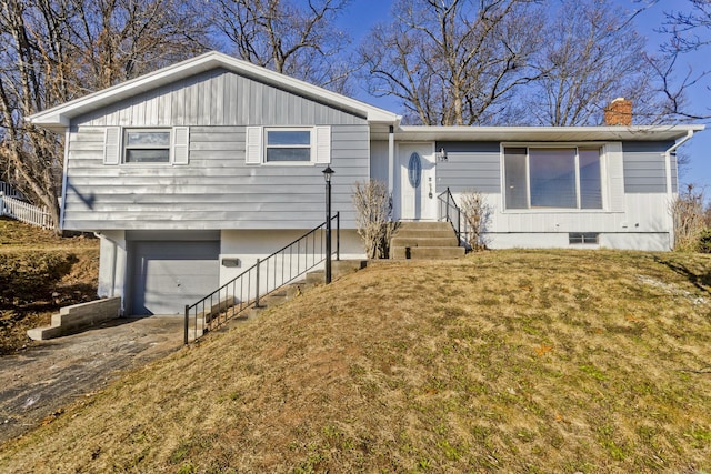 view of front of home featuring a garage and a front yard